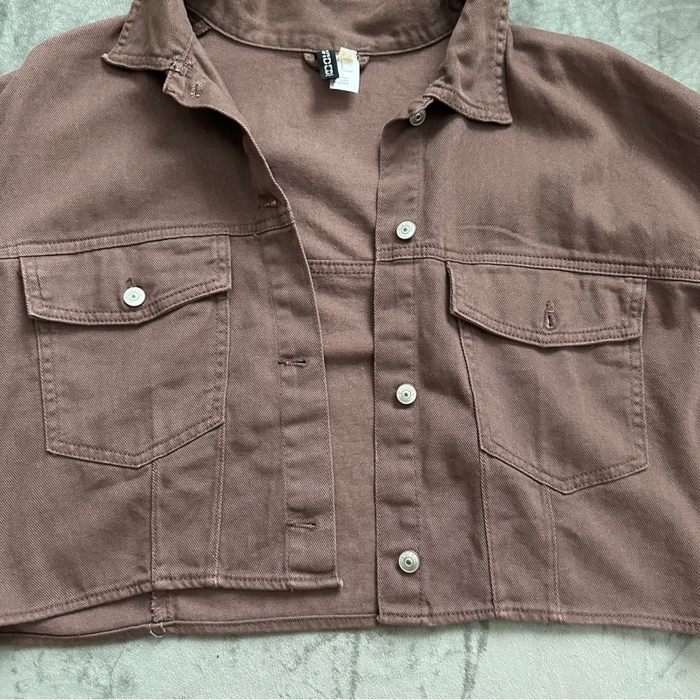 A brown jean jacket from Divide/H&M. Size is a large.